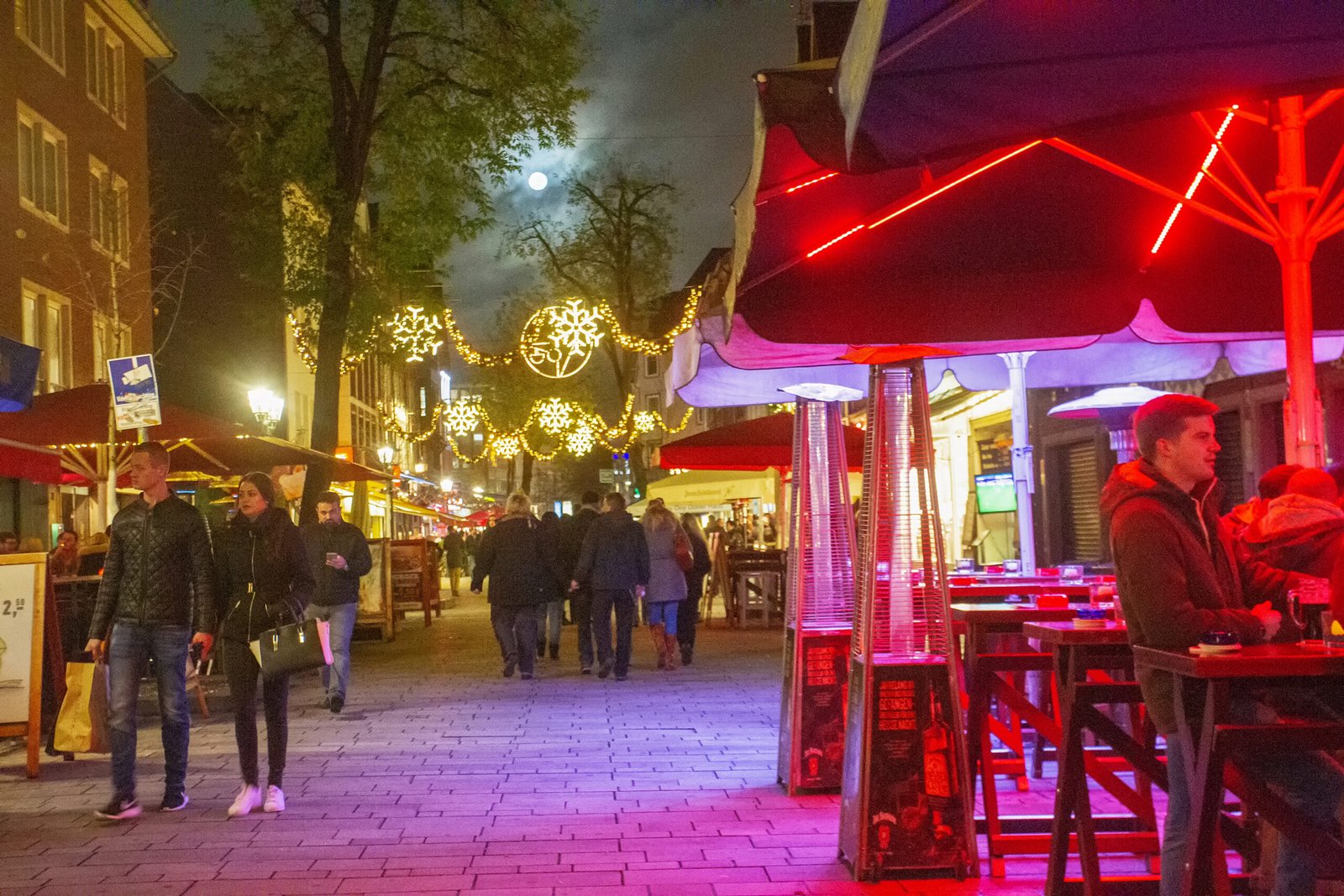 Night view on street in Dusseldorf People walking. 11/296/2015  Dusseldorf , Germany.  Night view on street in Dusseldorf People walking. Fool Moon in sky